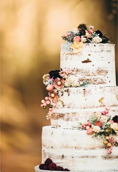 a white wedding cake with flowers on top