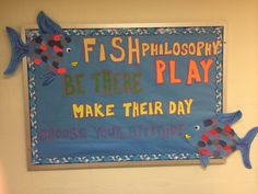 there is a sign on the wall that says fishphlosophy be there play make their day choose your attitude