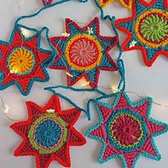 crocheted star ornaments hanging from string on table