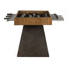 a wooden table topped with lots of metal objects on top of a cement slab,