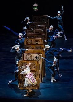 a group of people that are on stage with some boxes in front of each other