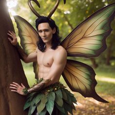 a man dressed as a fairy standing next to a tree