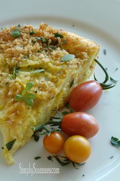 a piece of quiche on a plate with cherry tomatoes