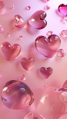 many pink hearts floating in the air on a pink surface with water droplets around them