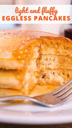 a stack of pancakes sitting on top of a white plate next to a knife and fork