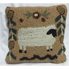 a decorative pillow with a sheep on it