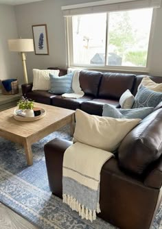 a living room filled with furniture and a rug on top of a wooden coffee table