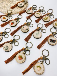 a collection of embroidered key chains with tassels