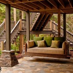 a porch with a couch and stairs in the background