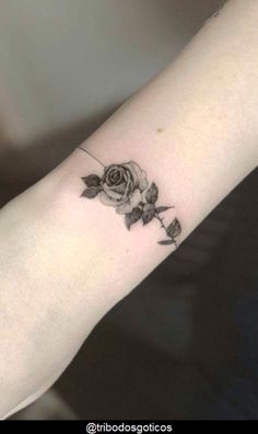 a small rose tattoo on the wrist