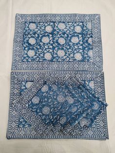 two blue and white bandannas on top of a tablecloth covered in cloth