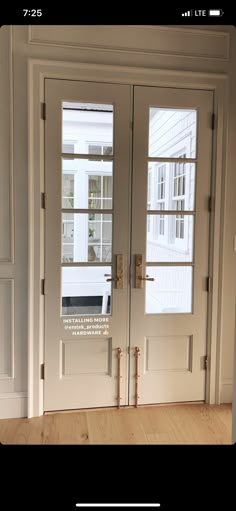 the front door to a house with two windows