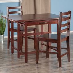 a wooden table with two chairs next to it