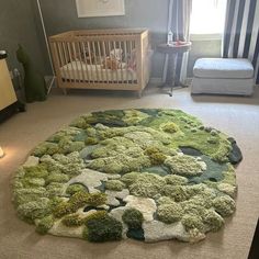 a baby's room with a green rug and crib in the background