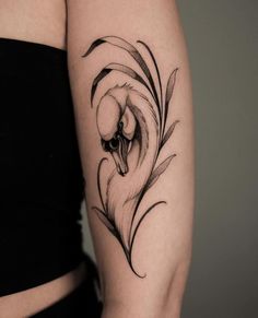 a woman's arm with a bird tattoo on it