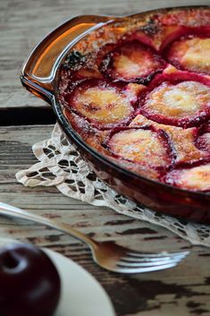 a dessert dish with fruit in it on a table