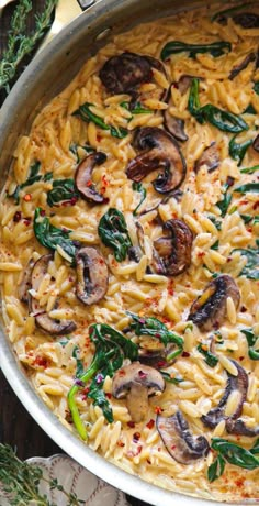 pasta with mushrooms and spinach in a pan