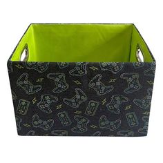 a black and green storage bin with cartoon drawings on the front, two handles at the bottom