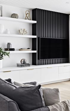 a modern living room with white shelves and black striped wallpaper on the tv screen