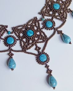 an ornate necklace with turquoise stones and beads