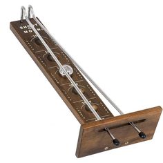 a wooden instrument with metal strings and holes in the middle, on a white background