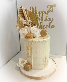 a white cake with gold decorations on top