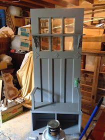 a gray cabinet sitting on top of a wooden floor next to boxes and other items