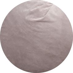 the round rug is made from light gray velvet