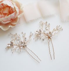 These sparkling gold wedding hair pins are sure to add beauty and floral beauty to your special day! Features brilliant top quality rhinestones in a floral cluster design mixed with brushed metal leaves and flower center for a very organic look, measuring 2 1/2" tall by 2 1/2" wide. This hairpin in handwired with silver colored wire, making the branches flexible to be moved to your liking. This gorgeous pin can be made in silver, yellow gold or rose gold. Choose from all crystals or with pearls. Gold Hair Pins, Pearl Hair Pin, Gold Hair Pin, Cluster Design, Rhinestone Hair Pin, Pearl Hair Pins, Wedding Hair Pins, Flower Center, Metal Leaves