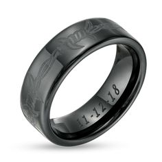 a wedding ring with an engraved design on it