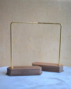 a pair of wooden stands on a marble table