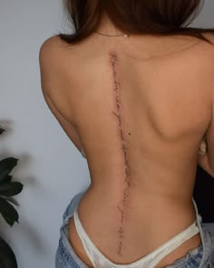 the back of a woman's lower back with writing on her left and right side