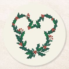 a white plate with holly and red berries on it