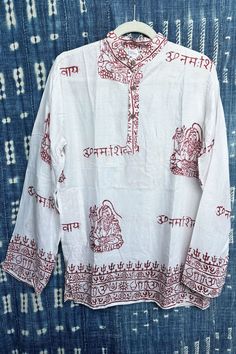 Lounge in true bohemian style, in our handmade Rayon block-printed Om Shirts from India. Looking laid-back has never been as easy as it is with these breezy shirts. Printed in traditional patterns, each shirt is unique and bears floral patterns, and Om, Ganesh, Shiva, or Buddha. Shirts have a pocket in the side panel. These shirts are handcrafted using a traditional Indian block-printing technique. We travel to the source to bring home these laid-back luxuries for you! Whether chilling on the bo Bohemian Cotton Shirt With Relaxed Fit, Long Sleeve Kurta For Rituals And Festivals, White Long Sleeve Bohemian Shirt, White Tunic Tops For Festival, White Cotton Tunic Shirt, Casual Long Sleeve Kurta For Festivals, Traditional Long Sleeve Relaxed Fit Blouse, Traditional Long Sleeve Kurta With Relaxed Fit, White Cotton Hippie Blouse