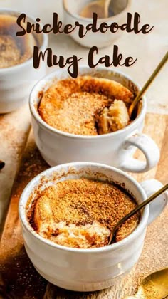 two white mugs filled with cake sitting on top of a cutting board