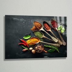 spoons and spices are arranged on a black surface