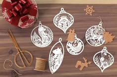 paper cut ornaments and scissors on a wooden table