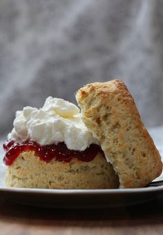 scones filled with cream and jam on a plate