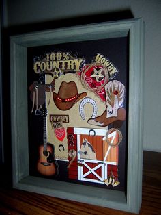 a shadow box with an image of a cowboy's hat and other items