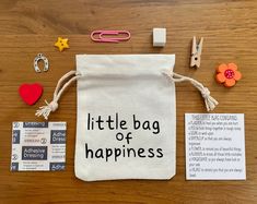 a little bag of happiness on a wooden table with paper clips, scissors and magnets