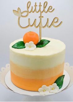 a cake with an orange and white frosting on top that says little curie