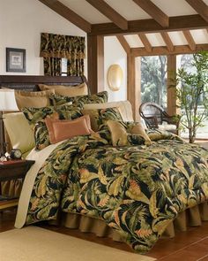 a bed covered in a green and yellow comforter next to a window with curtains