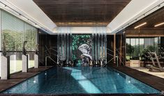 a large indoor swimming pool with an artistic mural on the wall and glass doors leading to it