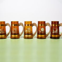 five beer mugs lined up in a row