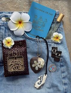 the back pocket of a pair of jeans with some charms and a passport on it