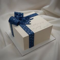 a white box with a blue ribbon on it