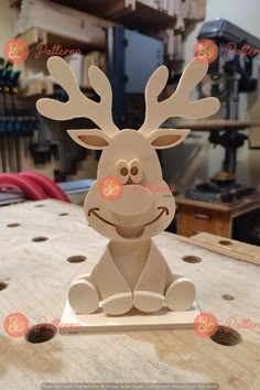 a wooden reindeer sitting on top of a table