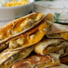 a stack of quesadillas stacked on top of each other in front of a bowl