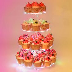 cupcakes are stacked on top of each other in the shape of a tower