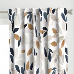 a white curtain with gold and blue leaves on it